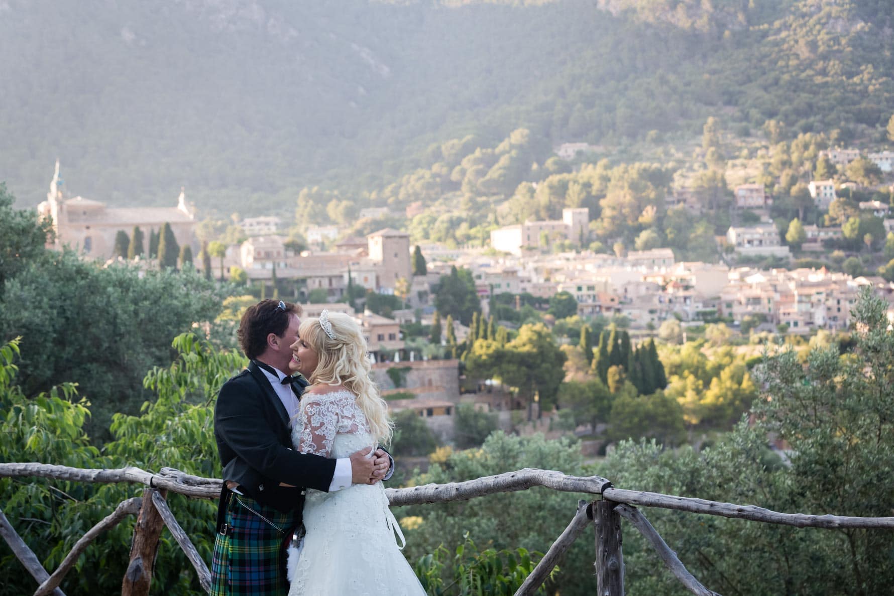 The newlyweds hug after their Mallorca wedding overlooking Valldemossa
