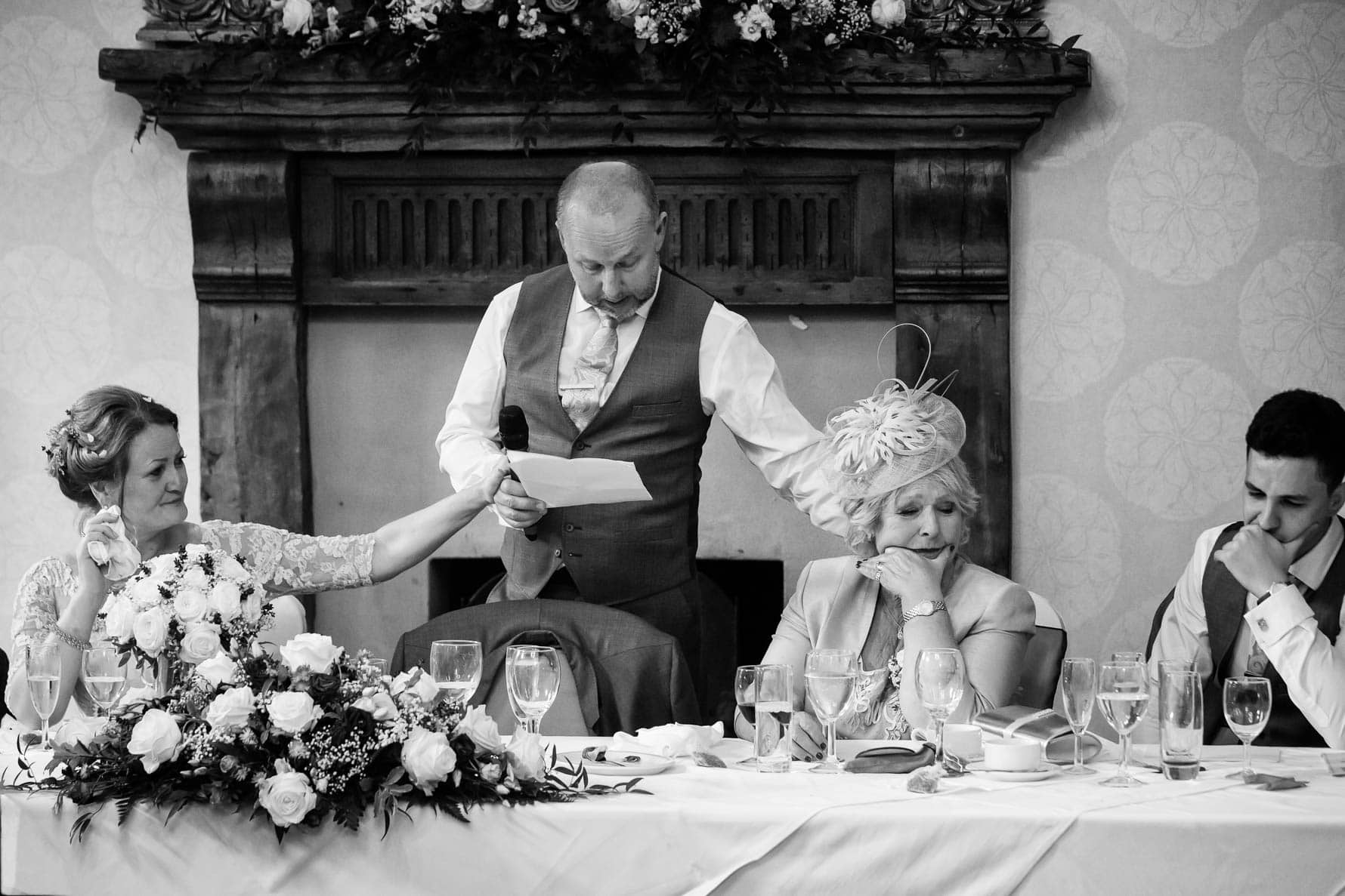 A touching moment at Hanbury Manor wedding in Hertfordshire by documentary wedding photographer Graham Warrellow