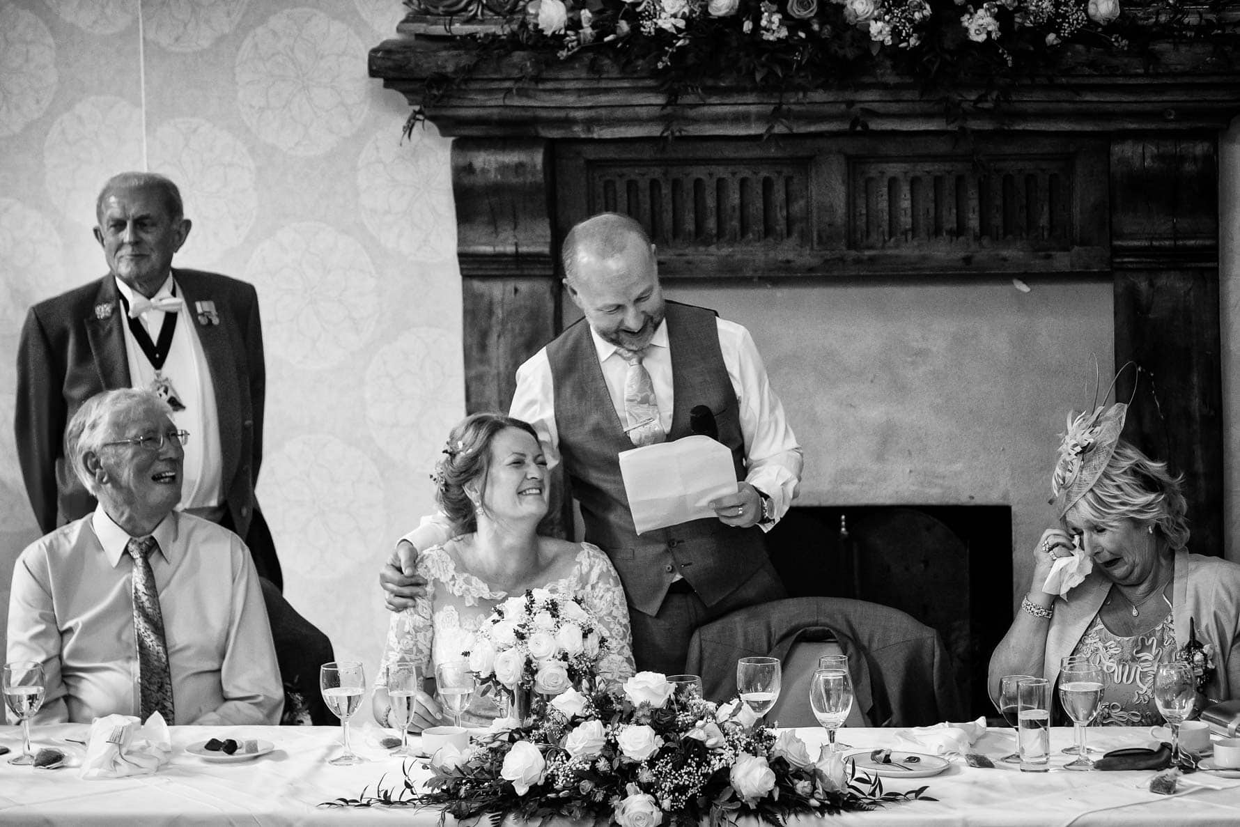 Bride and groom during speeches at Hanbury Manor wedding by Hertfordshire wedding photographer Graham Warrellow