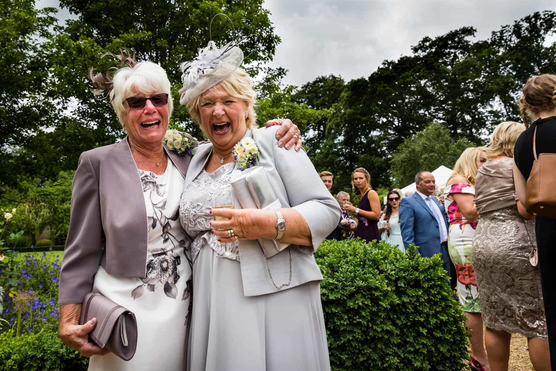 The bride and groom's mums laughing at Hanbury Manor wedding by Hertfordshire wedding photographer Graham Warrellow
