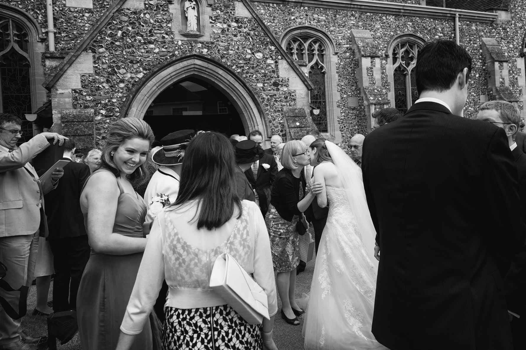 Happy guests after the wedding at St Mary's Church in Hertfordshire