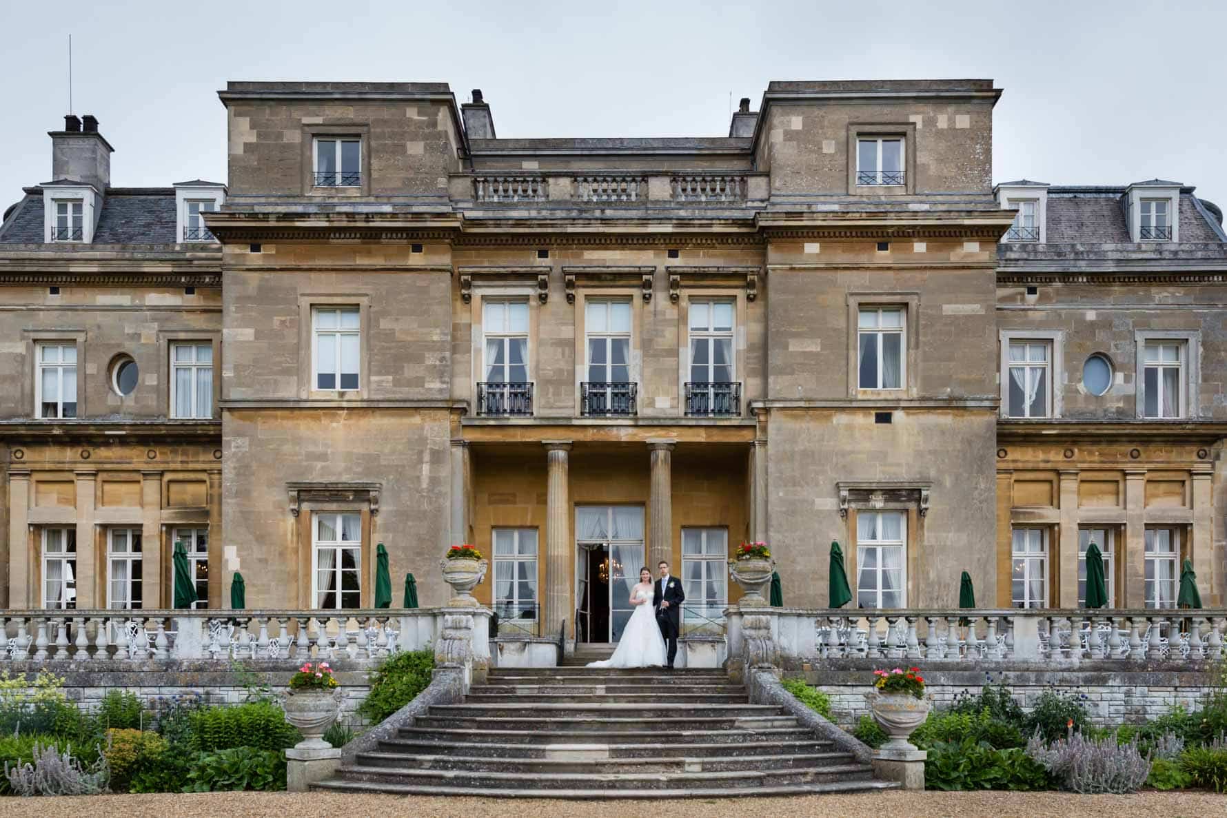 Bride and groom on steps at Luton Hoo wedding in Bedfordshire