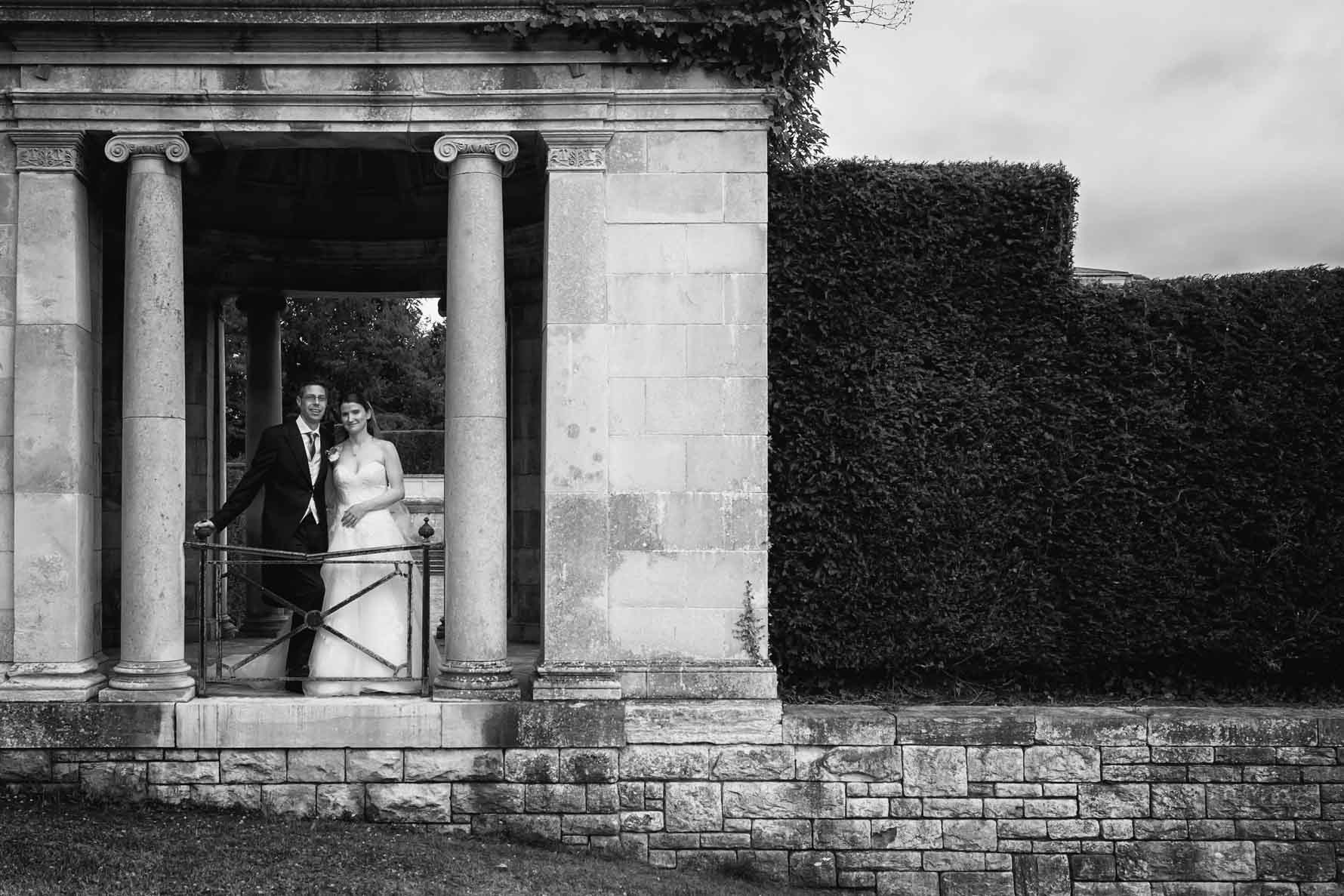Bride and groom under arch at Luton Hoo Hotel in Bedfordshire