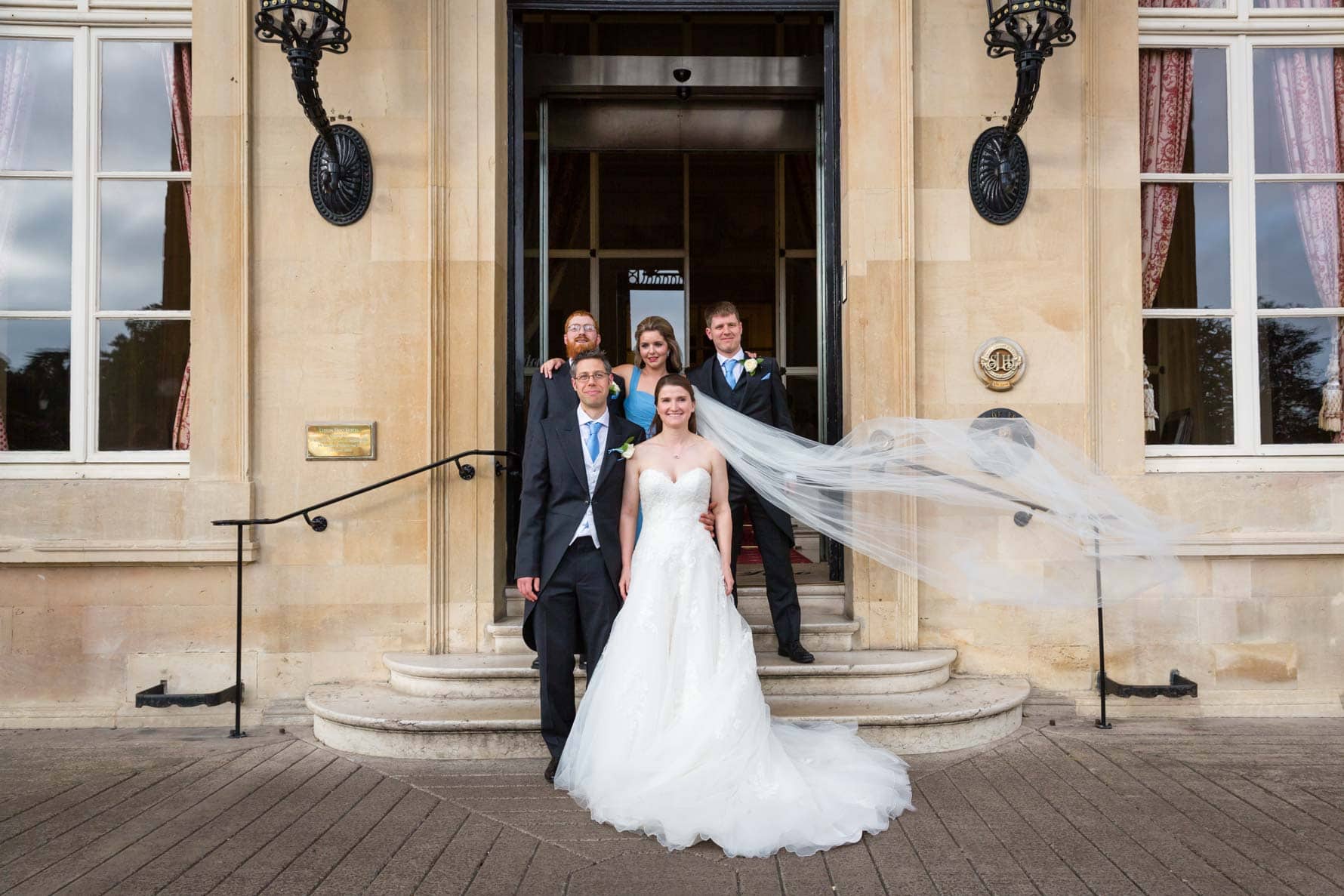 Bridal party on steps at Luton Hoo Hotel by Bedfordshire wedding photographer Graham Warrellow