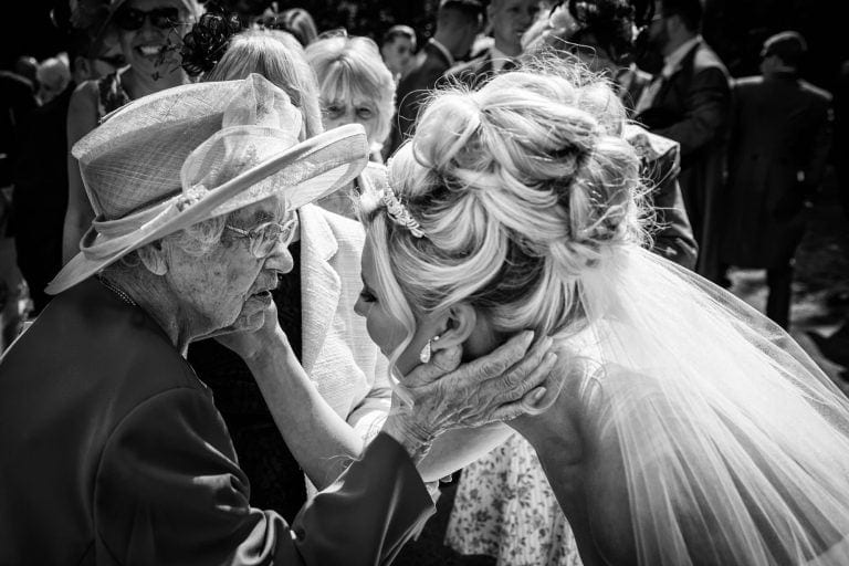Bride and 104 year old great grandmother touch each others faces at Bray wedding