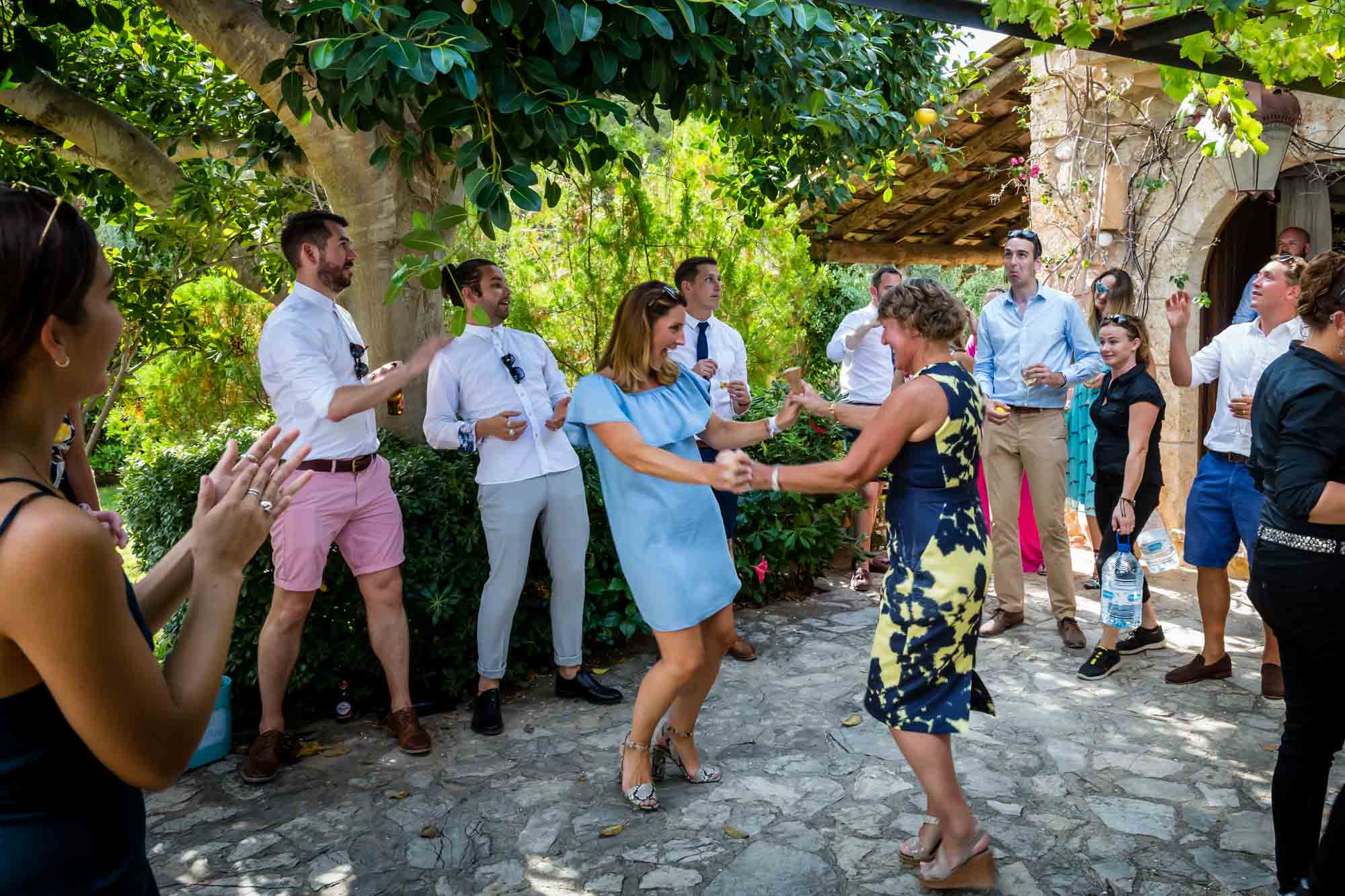 Dancing during the lemon game at Cathy and Ben's Mallorca finca wedding