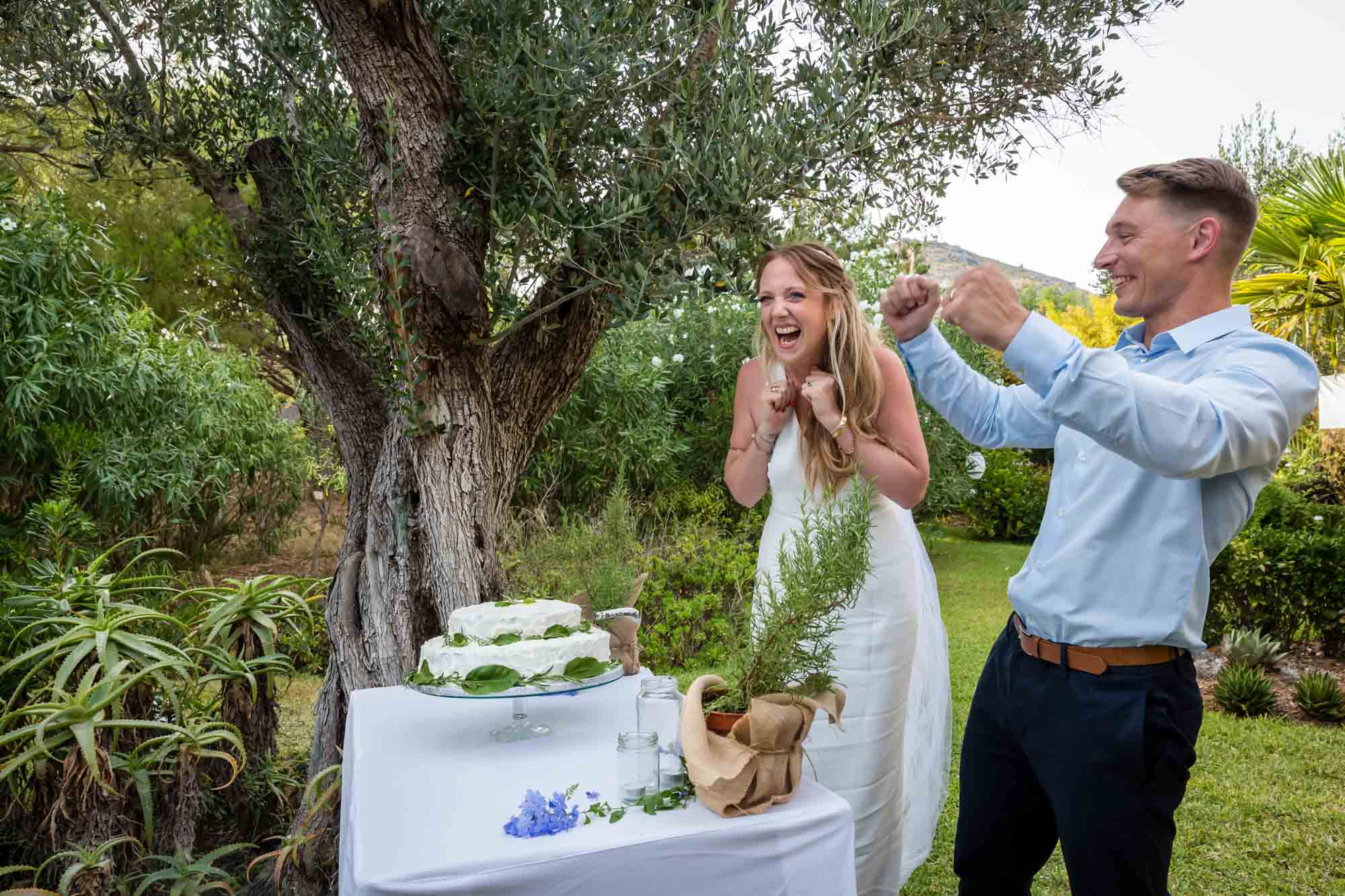 Cathy and Ben celebrate after cutting the wedding cake at their Mallorca finca wedding