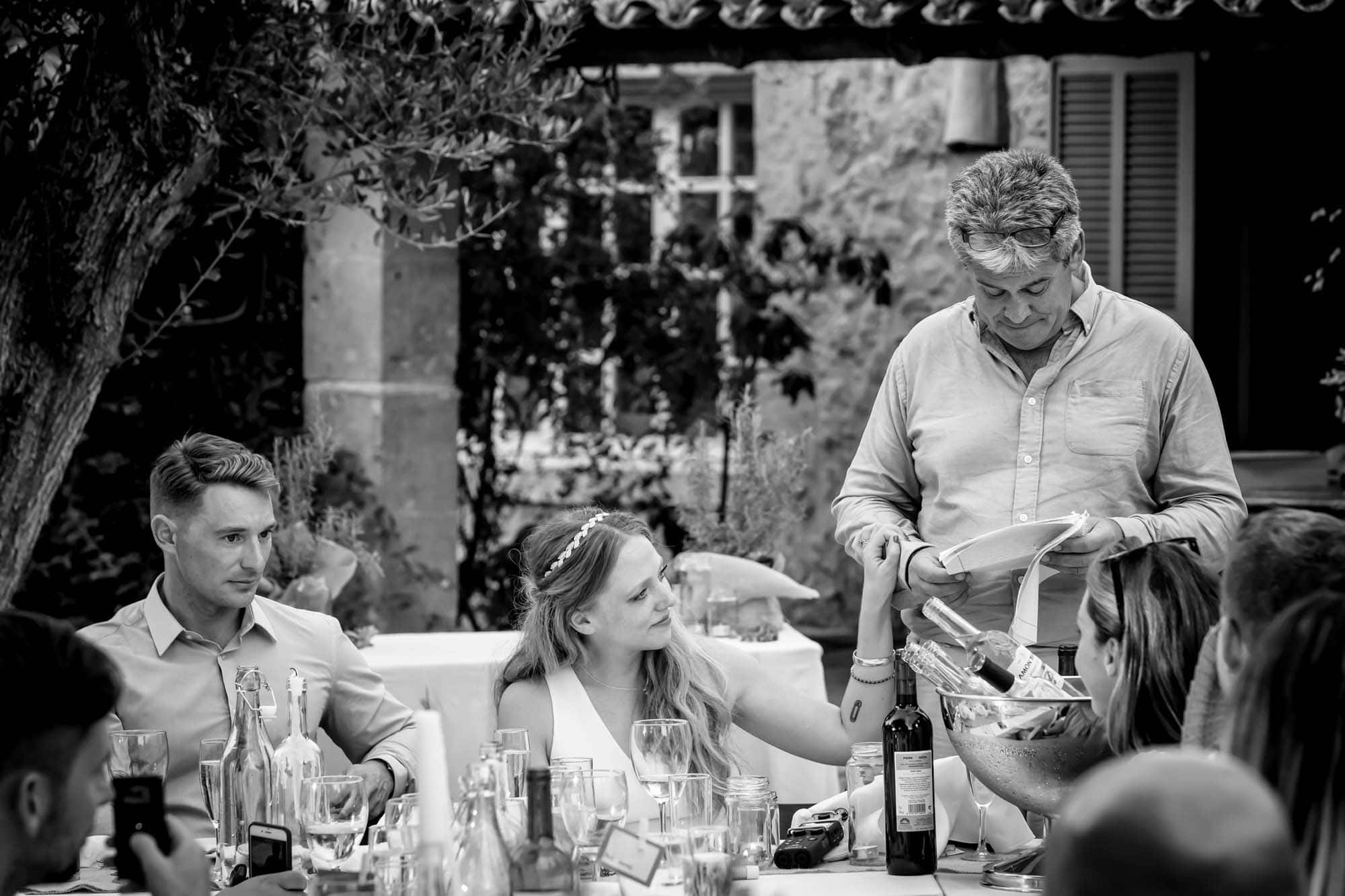 Cathy touches her dad's arm during his wedding speech by Mallorca wedding photographer Graham Warrellow
