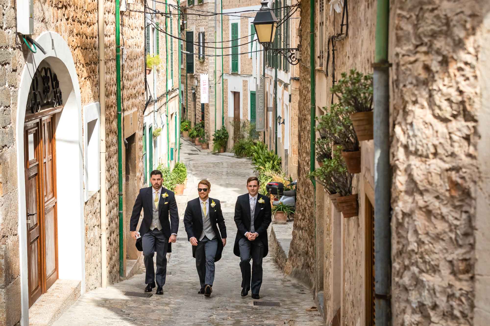 The groom and his bestmen leave Petit Hotel in Fornalutx, Mallorca