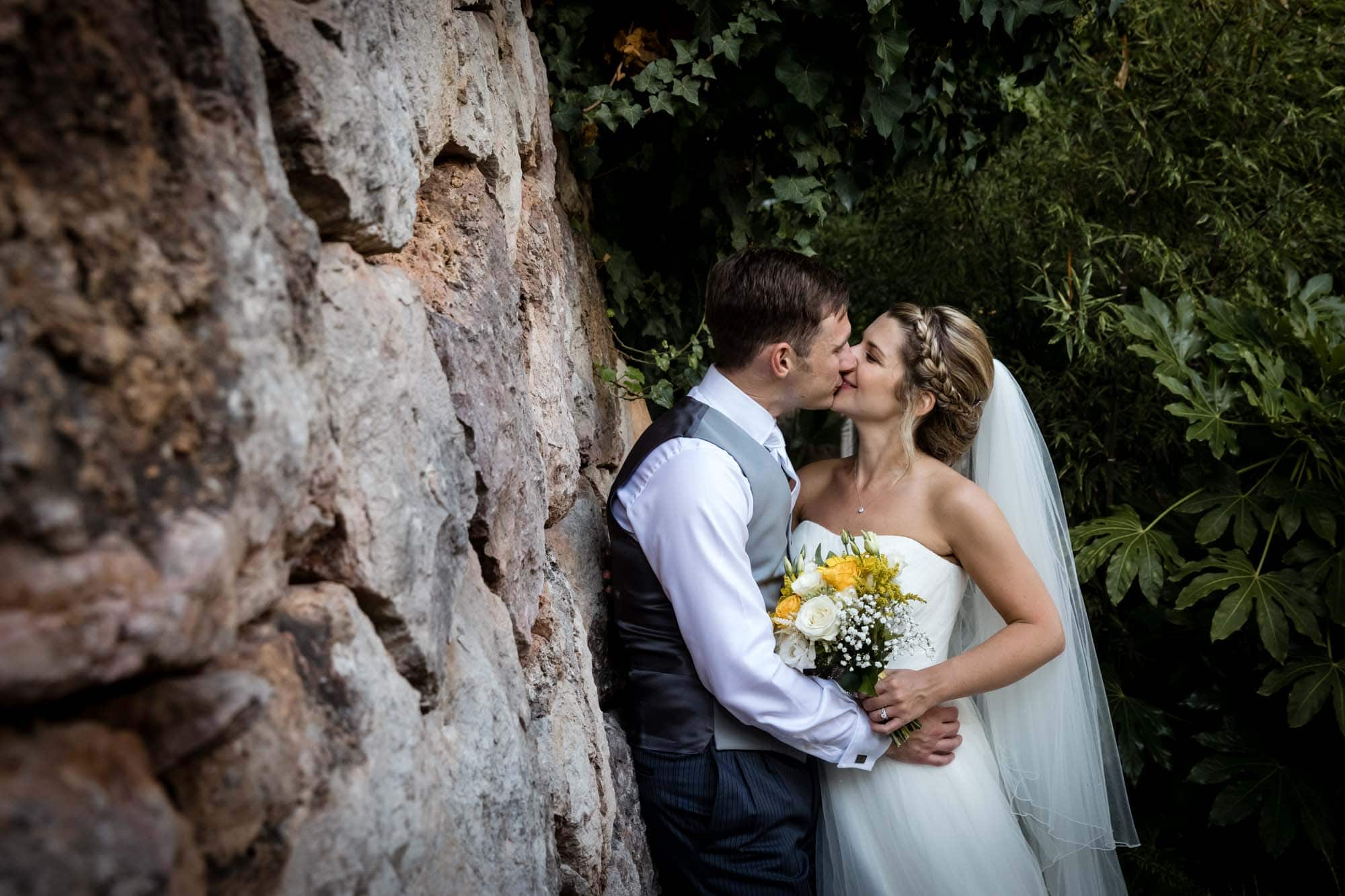 Bride and groom kissing in the garden at Hotel Can Verdera by Mallorca destination wedding photographer Graham Warrellow