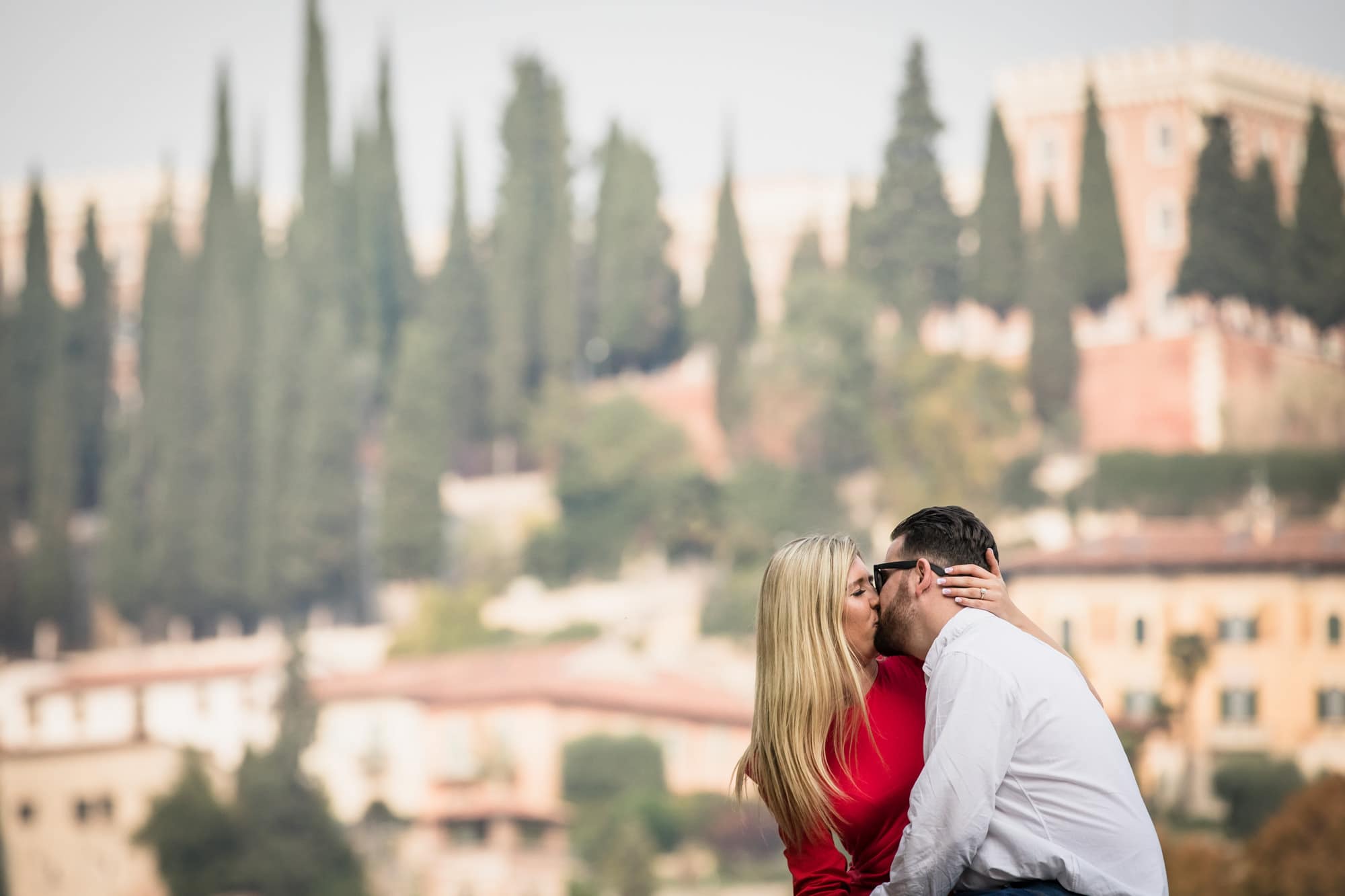 Romantic couple kissing beside the River Adige in Verona, Italy