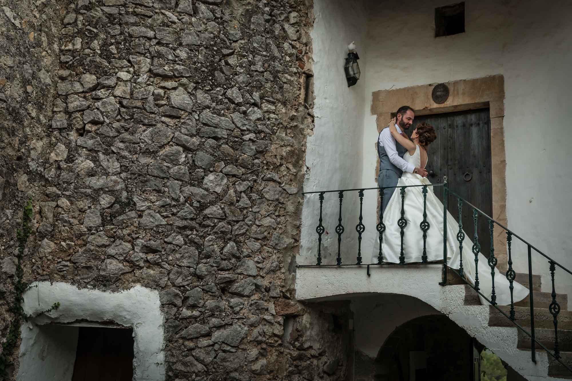 Bride and groom at top of stairs at Pedruxella Gran