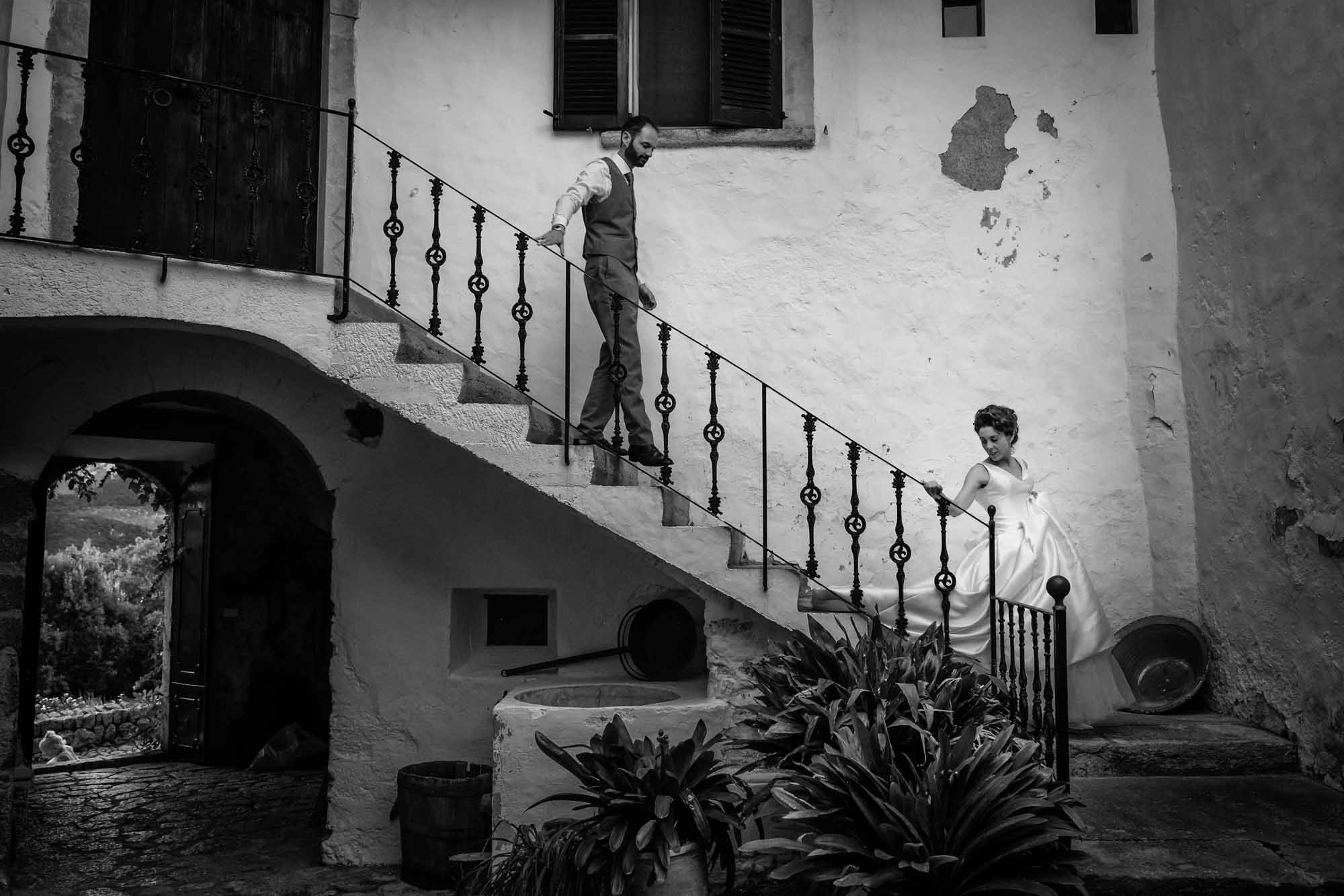 Bride and groom descend the staircase at Pedruxella Gran