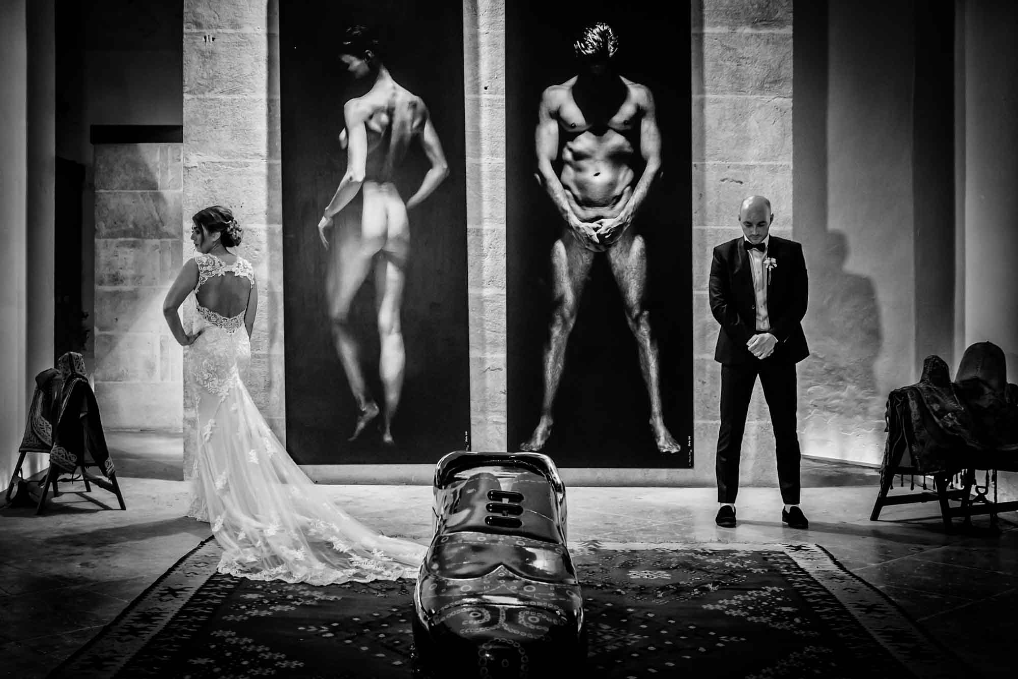 Bride and groom pose with naked man and woman and shoe at Cap Rocat